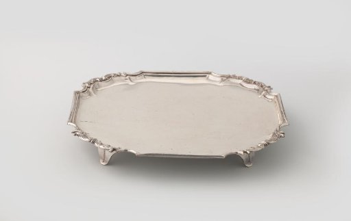 Silver presentation plate on four feet. Square with applied profile border.