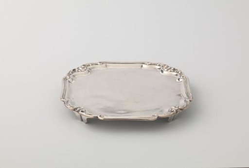 Sheet, square, with arched sides and recessed, scalloped corners, resting on four feet