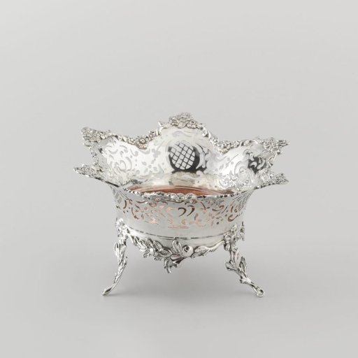 Stove of silver on three legs. Vessel with six-pointed openwork rim. Inner basin of copper.
