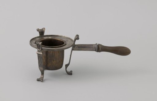 Stove of silver with a wooden handle. Inner basin of copper.