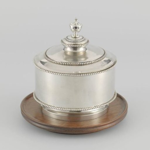 Silver tobacco pot decorated with pearl borders, on a wooden stand