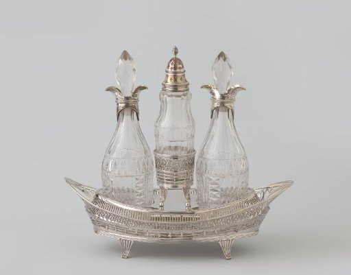 Sugar scoop belonging to an oil and vinegar set consisting of two bottles and a sugar scoop in an oval holder