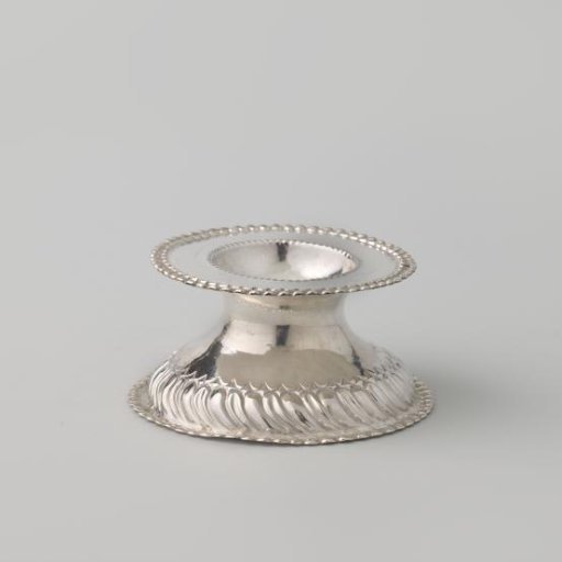 Salt cellar of silver with a high-arched foot surrounded by a wreath of knobs