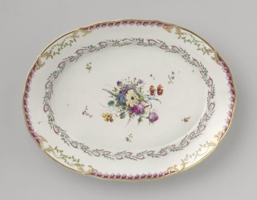 Plate, flat, large and oval, belonging to a service with a swirled ribbon motif with leafy branches, floral bouquets, and scattered flower branches