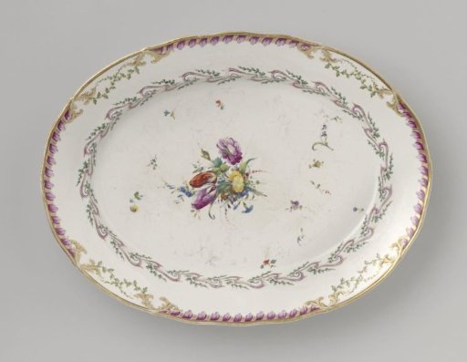 Plate, flat, large and oval, belonging to a service with a swirled ribbon motif with leafy branches, floral bouquets, and scattered flower branches