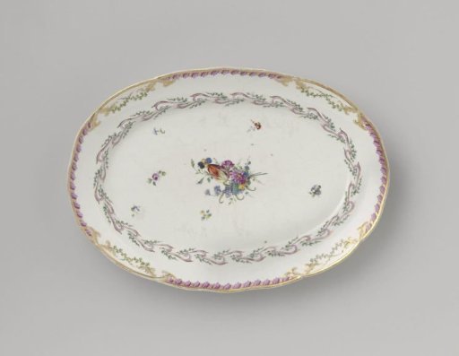 Dish, flat and oval in shape, belonging to a service with a swirled ribbon motif with leafy branches, flower bouquets and scattered flower sprays