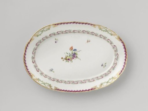 Dish, flat and oval in shape, belonging to a service with a swirled ribbon motif with leafy branches, floral bouquets and scattered flower branches