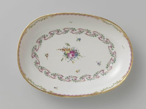 Bowl, deep and oval in shape, belonging to a service with a swirled ribbon motif with leafy branches, floral bouquets and scattered flower branches