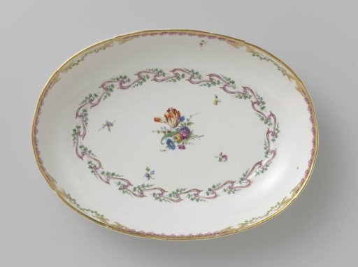 Bowl, deep and oval in shape, belonging to a service with a swirled ribbon motif with leafy branches, floral bouquets and scattered flower branches