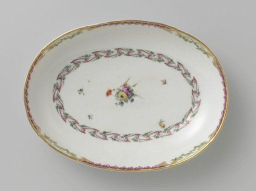 Bowl, deep and oval in shape, belonging to a service with a swirled ribbon motif with leafy branches, floral bouquets and scattered flower branches