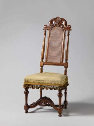 Walnut chair with a sculpted back in the middle decorated with carving
