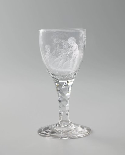 Wine glass with three playing boys