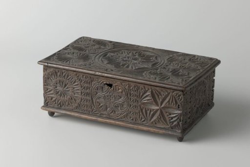 Chest decorated with chip-carved ornaments including a vase with tulips