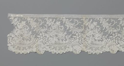 Strip of needle lace with volutes and peonies