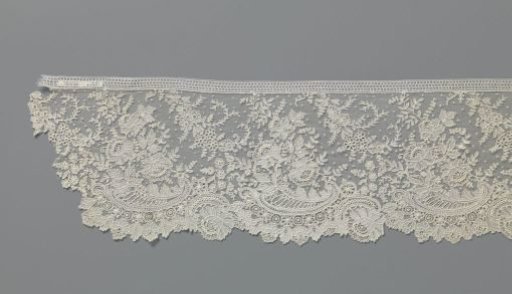 Strip of needle lace with volutes and peonies