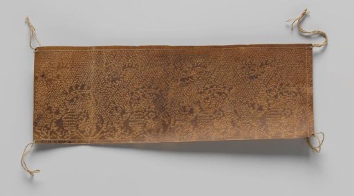 Pattern for a strip of bobbin lace on brown parchment with curved leaves and scattered flowers at the top