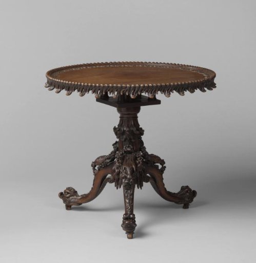 Table with a folding leaf. On the three-split legs, pecking birds and dragon heads.