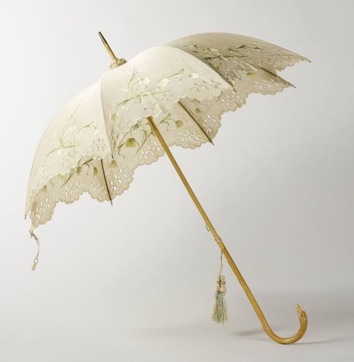 Parasol with canopy of ecru linen with embroidery on a shaft of light wood with a knob in the shape of a bird's head