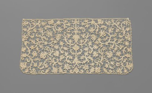 Jabot of needle lace with a symmetrical pattern based on a candelabre motif on the central axis, including lotus flowers