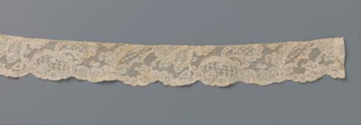 Strip of bobbin lace with overlapping organic forms including rocaille and leaves