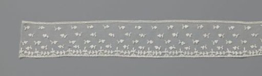 Strip of appliqué lace with rows of clover leaves