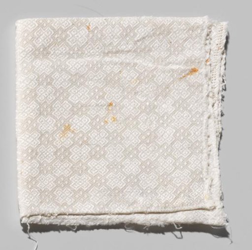 Napkin, fragment of white linen damask with a pattern of lattice