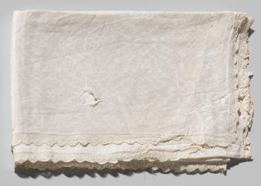 Napkin with a large cross-stitch and goose-eye pattern, edged with scalloped bobbin lace