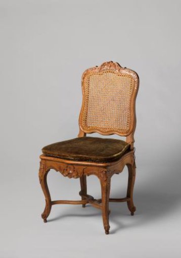 Chair of walnut and beech with S-shaped splayed legs; X-shaped stretcher with rosette; carved floral and foliate work, rush seat and back, with loose cushion