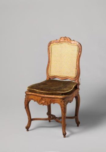 Chair of walnut and beech with S-shaped splayed legs; X-shaped stretcher with rosette; carved floral and foliate work, rush seat and back, with loose cushion