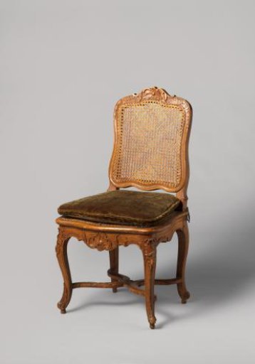 Chair of walnut and beech with S-shaped splayed legs; X-shaped stretcher with rosette; carved floral and foliate work, rush seat and back, with loose cushion