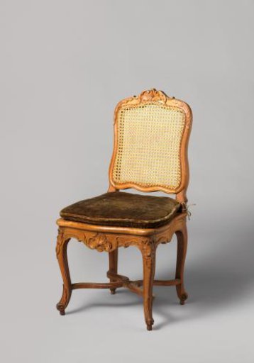 Chair of walnut and beech with S-shaped splayed legs; X-shaped stretcher with rosette; carved floral and foliate work, rush seat and back, with loose cushion