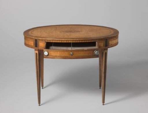 Table, Oval, Veneered with Various Woods, on Conical Legs Decorated with Three Triangles Each Below a Molding. Top with Central Oval Motif of Musical Instruments