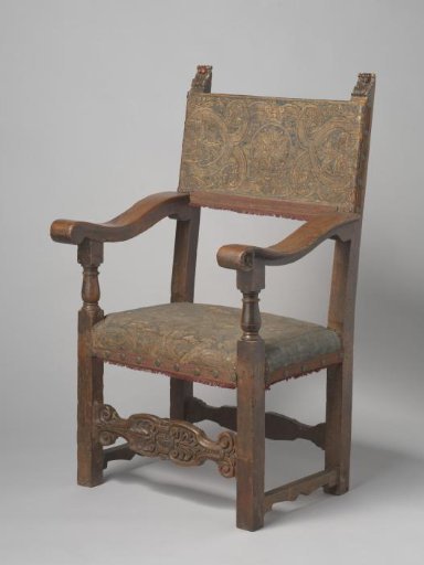 Armchair of walnut, upholstered in gold leather