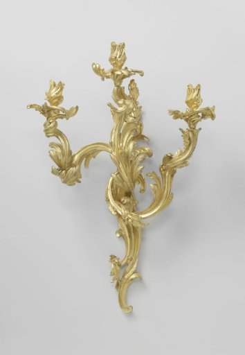 Wall sconce of gilded bronze with three arms built up from asymmetrical C- and S-scrolls.