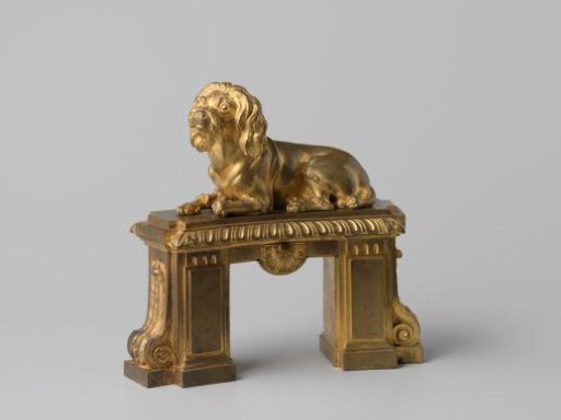 Fire dog of gilded bronze with a recumbent dog