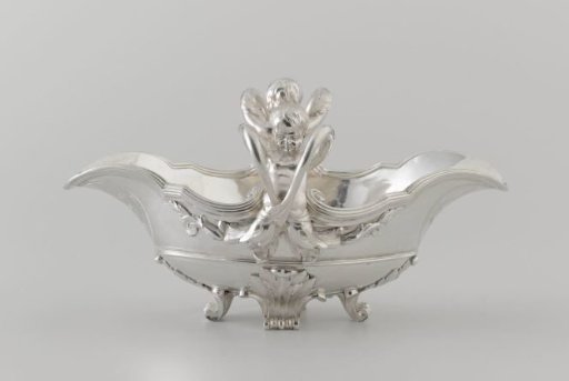 Sauce boat with child figures on the short side, their arms forming handles