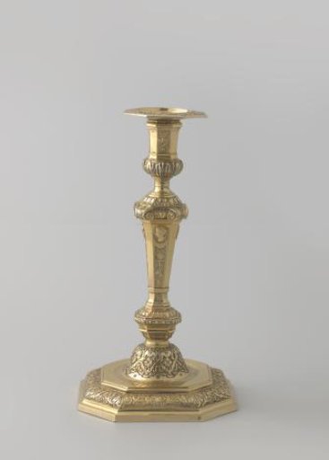 Candelabrum, part of a pair, of gilt silver. Decorated on the stem with trophies and musical instruments above which profile heads in medallions