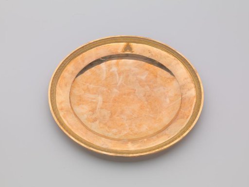 Plate of gilded silver, with a palmette border. On the flat surface the engraved coat of arms of Potemkin.