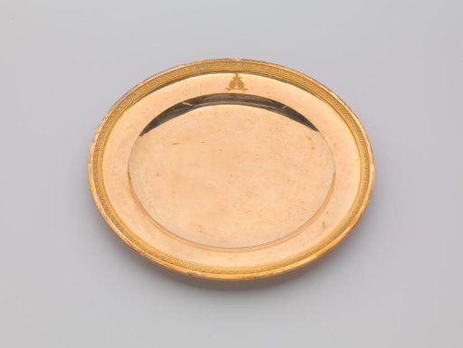 Plate of gilded silver, with palmette border. On the face the engraved coat of arms Potemkin.