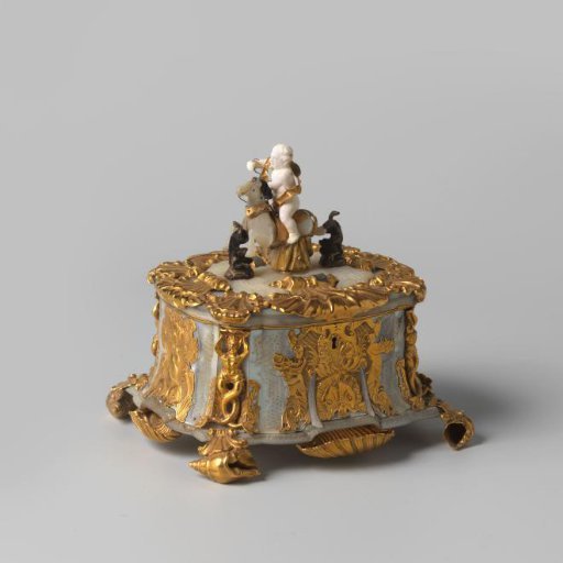 Chest, rectangular, of mother-of-pearl with mount and ornamentation of gold. On the lid a putto of ivory, riding on a horse of mother-of-pearl