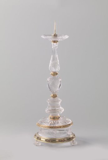 Candelabrum with candle socket and drip pan of rock crystal in a mount of gold and gilded silver with enamel. Foot decorated with garlands and bunches of fruit in cut work.
