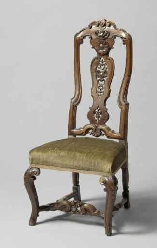 Walnut armchair with high back carved with C-scrolls and sunflowers; diagonally placed S-shaped front legs; cross with scalloped side supports