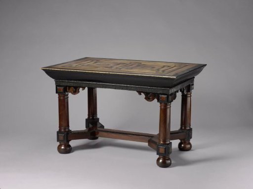 Table with legs in the form of Tuscan columns with houses, connected by a double Y-shaped cross and resting on spheres. Veneered with rosewood and ebony