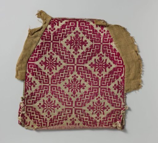 Fragment of chair upholstery in red and white velvet