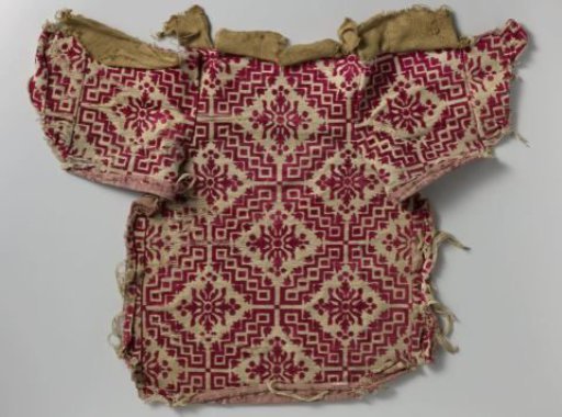 Fragment of chair upholstery in red and white velvet