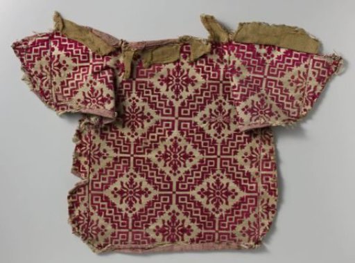 Fragment of chair upholstery in red and white velvet