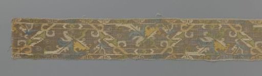Strip of coloured lace embroidery with vine leaf