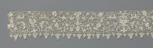 Strip of needle lace with candelabra motifs and coral vines