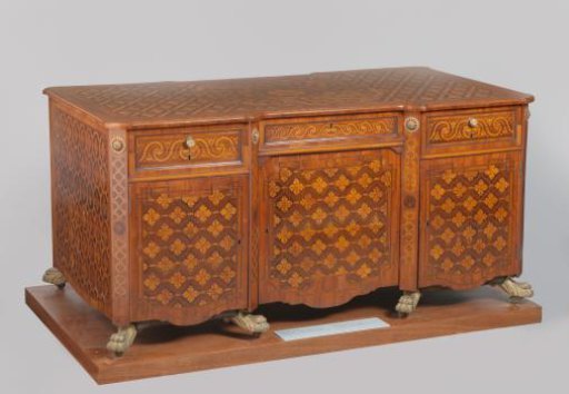 Desk, three-part, with retracting central section, accentuated by angled stiles with bronze lion's paws. Veneered with multiple wood species.