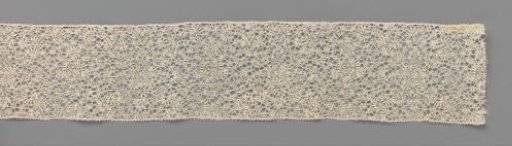 Strip of bobbin lace with human-like figures made of narrow decorative ribbons with rectangular shapes